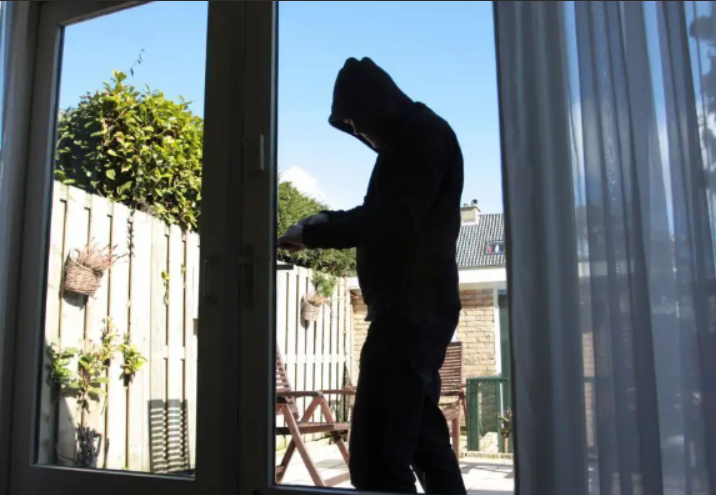 a burglar trying to break in through a patio door